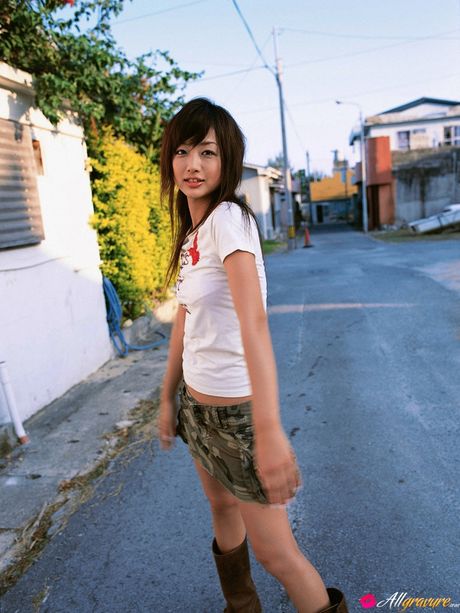 Asian teen Risa Kudo demonstrates her nice tits and poses in a red dress