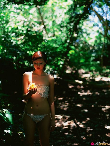 Asian doll Rina Nagasaki gets naked on a blanket on a sandy beach