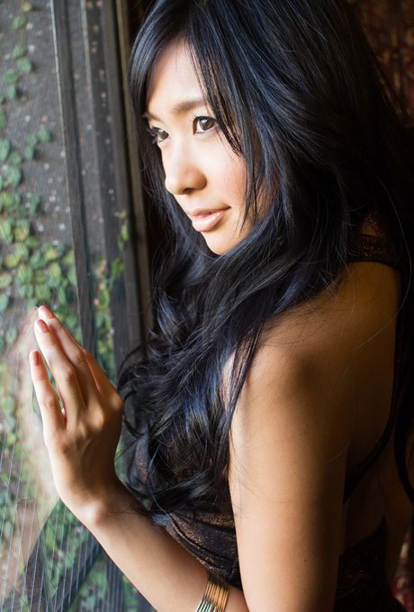 Asian doll Nana Ogura removes her dress and poses in fishnet stockings