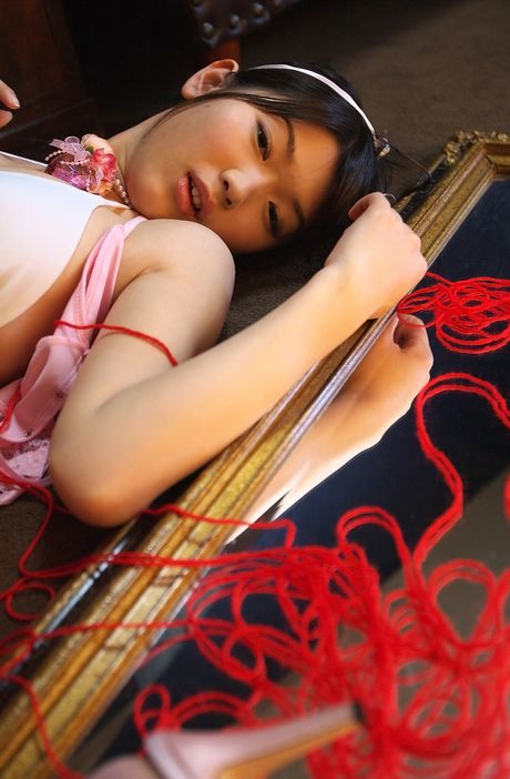 Asian beauty Noriko Kijima highlights her big racks and poses in fishnet stockings