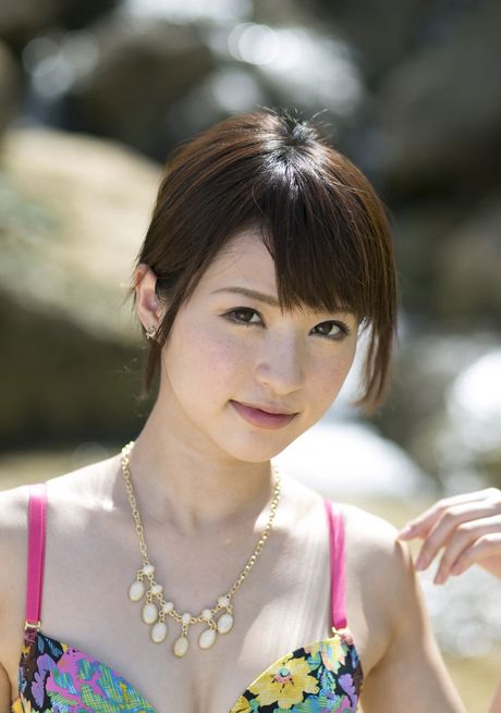 Asian teen Angel Moe removes her bikini to pose nude on a rocky cliff