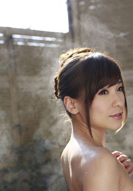 Asian model Kaho Kasumi gets completely naked on a bed sensually