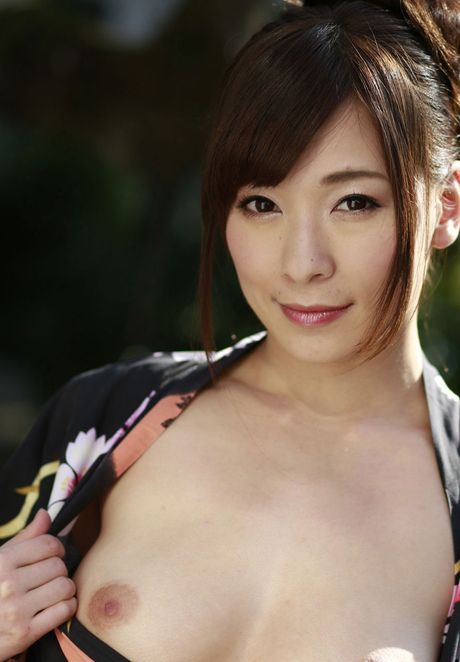 Asian model Kaho Kasumi gets completely naked on a bed sensually