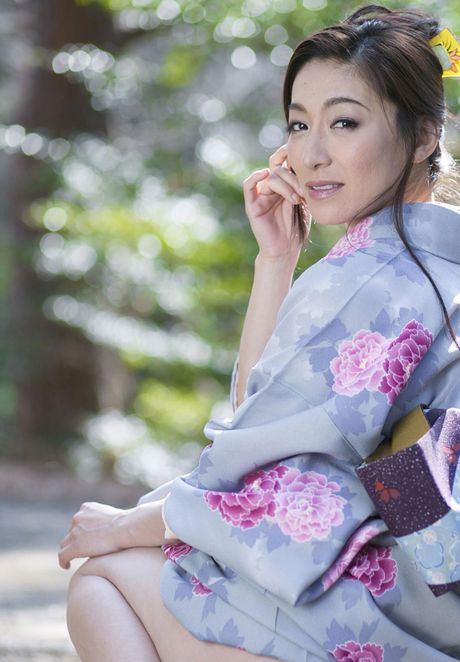 Asian model Marina Matsumoto removes a kimono to get naked in a bedroom