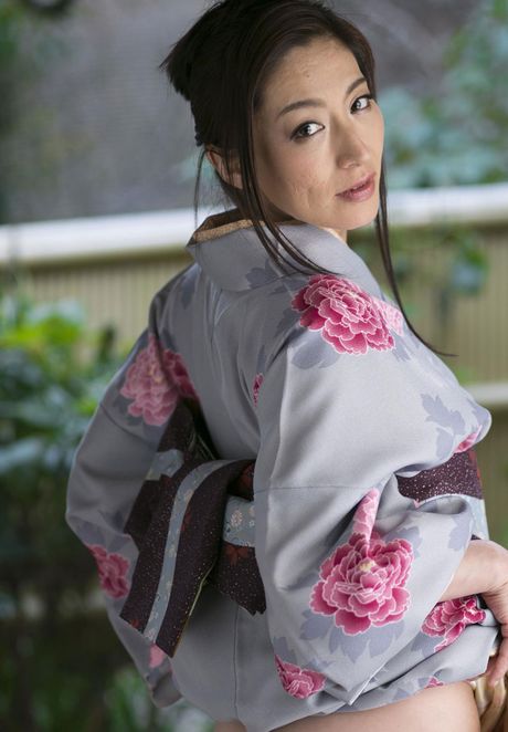 Asian model Marina Matsumoto removes a kimono to get naked in a bedroom