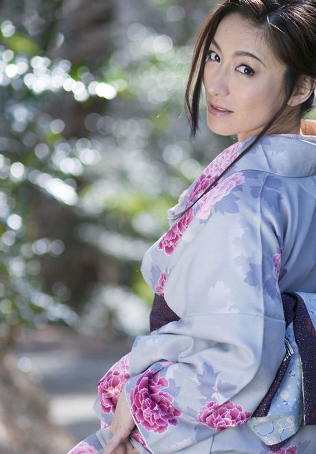 Asian model Marina Matsumoto removes a kimono to get naked in a bedroom