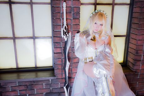 Blonde japanese girl Saku models a white wedding dress in white stockings