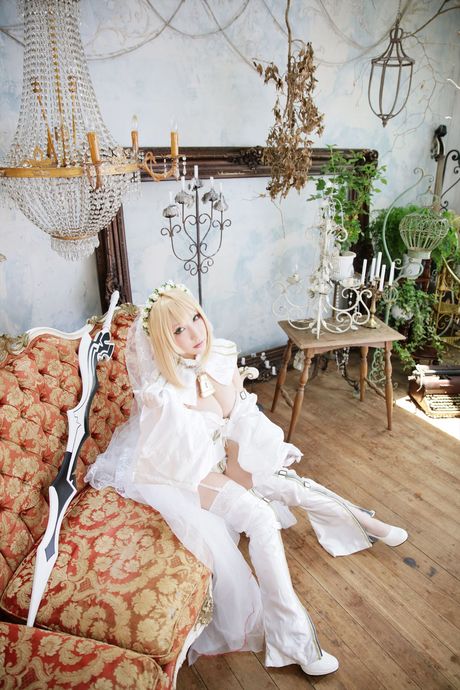Blonde japanese girl Saku models a white wedding dress in white stockings