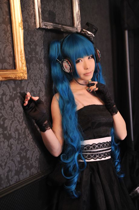 Asian stunner Haruka models a black dress and gloves in a masquerade