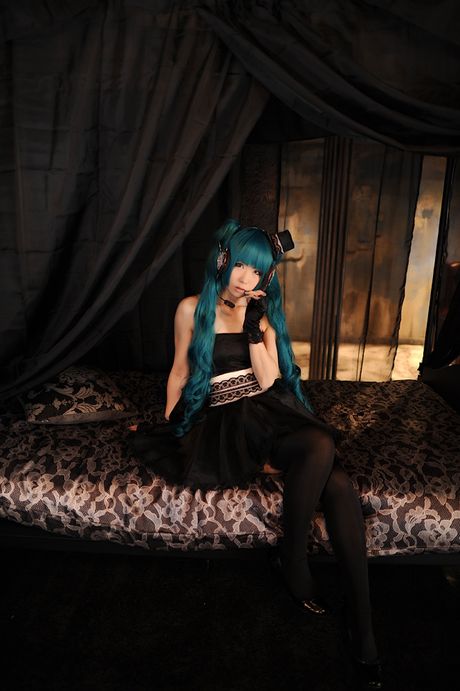 Asian stunner Haruka models a black dress and gloves in a masquerade