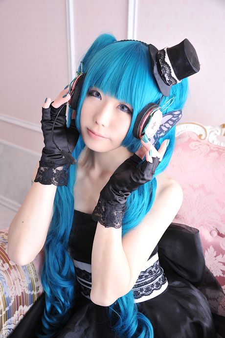 Asian stunner Haruka models a black dress and gloves in a masquerade