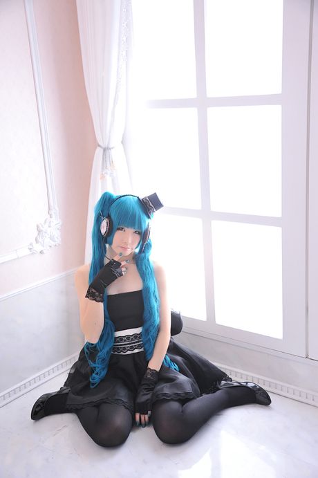 Asian stunner Haruka models a black dress and gloves in a masquerade