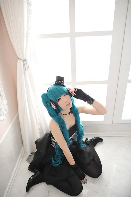 Asian stunner Haruka models a black dress and gloves in a masquerade