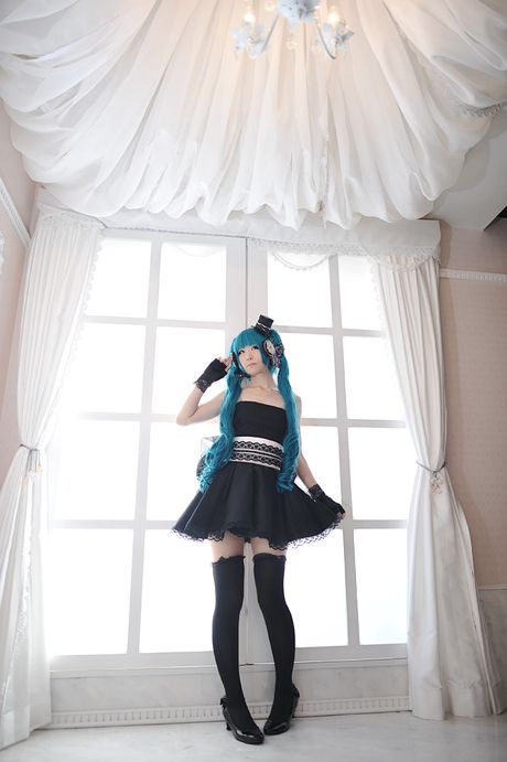 Asian stunner Haruka models a black dress and gloves in a masquerade