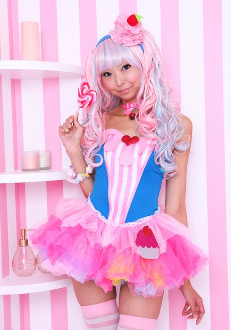 Asian covergirl Necoco demonstrates her petite small tits and poses in striped stockings