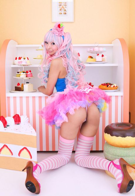 Asian covergirl Necoco demonstrates her petite small tits and poses in striped stockings