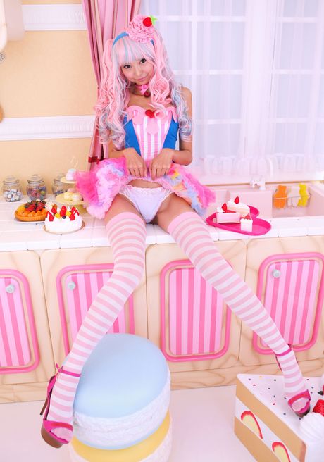 Asian covergirl Necoco demonstrates her petite small tits and poses in striped stockings