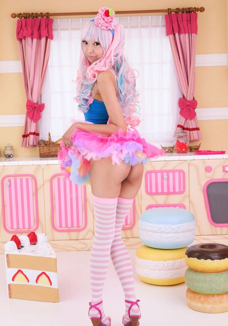 Asian covergirl Necoco demonstrates her petite small tits and poses in striped stockings