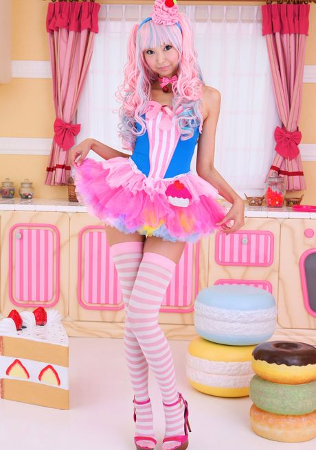 Asian covergirl Necoco demonstrates her petite small tits and poses in striped stockings