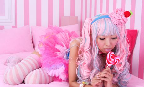 Asian covergirl Necoco demonstrates her petite small tits and poses in striped stockings