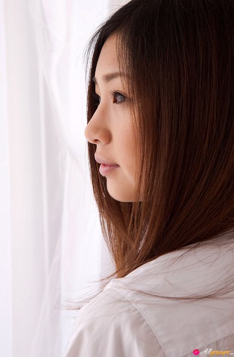 Asian cutie Ayaka Sayama gets naked on a bed in a pleated skirt