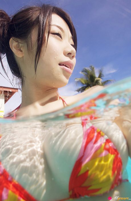 Asian girl Fumina Suzuki gets naked in a pool before a nude swim