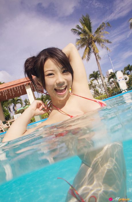 Asian girl Fumina Suzuki gets naked in a pool before a nude swim