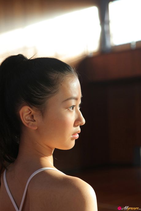 Superb Asian babe Aino strips her swimsuit and flaunts her large boobs