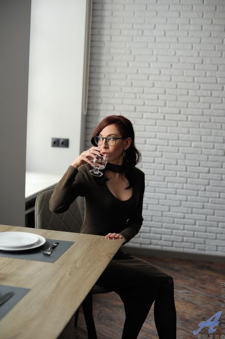 Mature redhead Gwen shows her big tits and poses in stockings