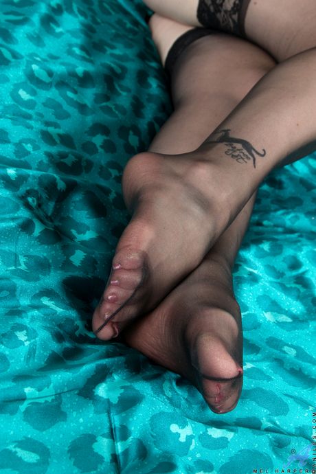 Blonde housewife Mel Harper shows her big tits and poses in stockings