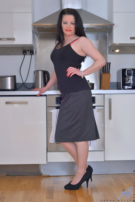 Hot british brunette aged Sarah Kelly unveils tiny tits and pussy in kitchen