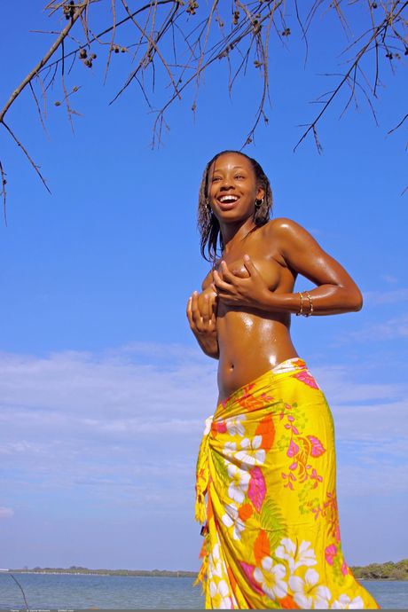 Tierra oils up her big tits and ass outdoors as she poses nude