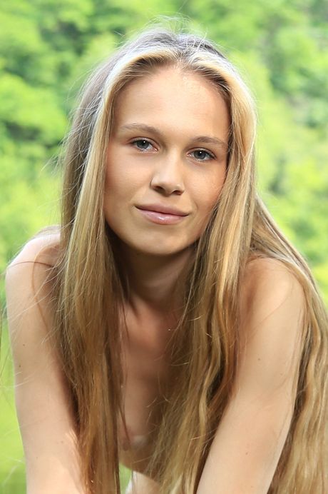 Long legged teen Nela Decker gets nude on a blanket in a field