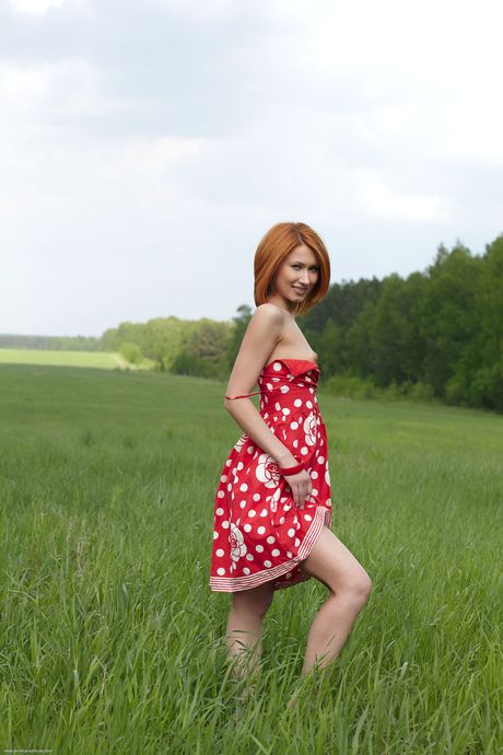 Russian redhead Judite gets naked on a blanket in the backyard