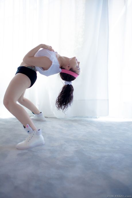 Tattooed pornstar Gabriella Paltrova displays her perfect ass and big tits