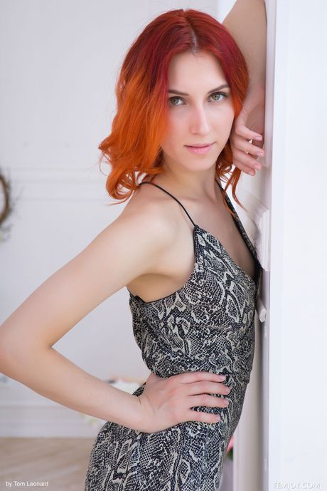 Redhead russian,latvian girl Elin Flame displays her small tits and reveals her naked form