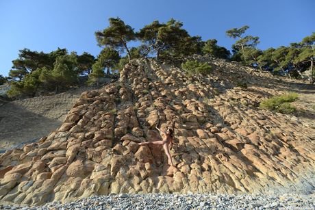 Lean russian teen Foxy Di bares herself on a rocky outcropping