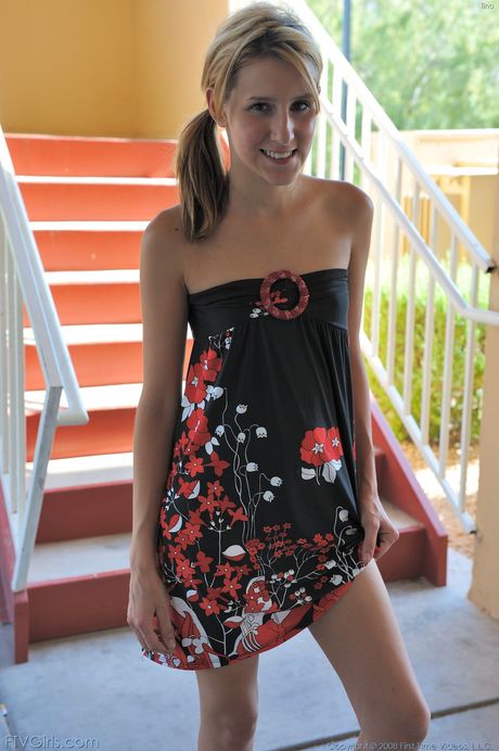 Alluring blonde teen Kiki gets naked before toying her pussy in a bedroom