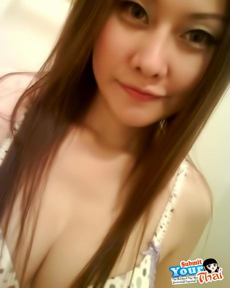 Brown-Eyed thai beauty Amateur Girl shows off her massive tits and poses in a solo