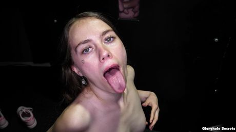 Nice american teen Sia Wood removes a black dress before sucking a dick through a hole