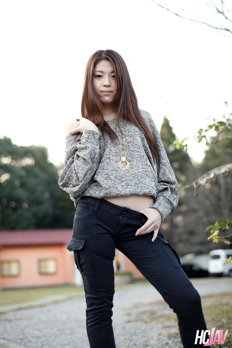 Asian teen Ayaka Minamino demonstrates her nice tits and poses in the street
