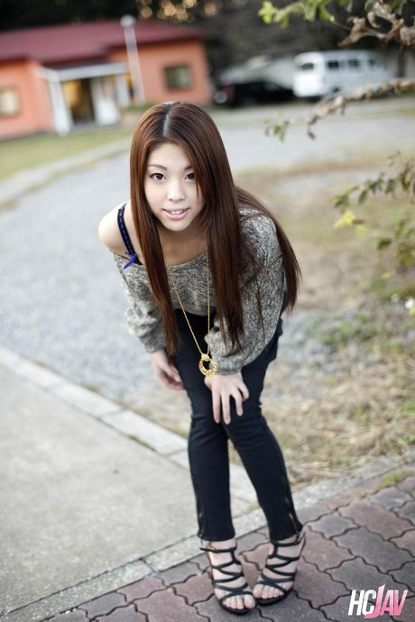 Asian teen Ayaka Minamino demonstrates her nice tits and poses in the street