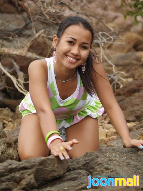 Asian covergirl Joon Mali shows her petite tits and rubs her clit outdoors