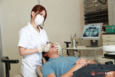 Big-breasted Asian nurse Yume Mizuki strips and flaunts her amazing tits in a solo