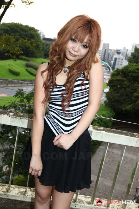 Attractive Asian teen Sarina Tsubaki strips and demonstrates her big tits outdoors