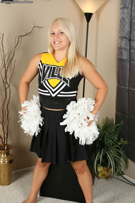 Blonde cheerleader Naomi reveals her amazing juggs and ass in a solo