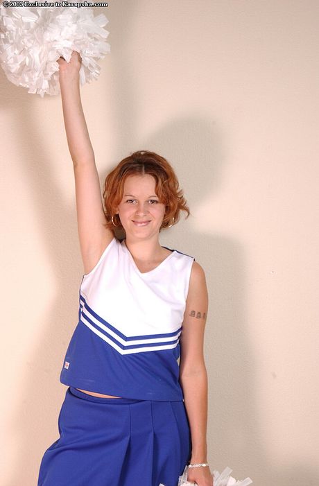 Excellent cheerleader Joyce strips and demonstrates her small tits and her shaved pussy