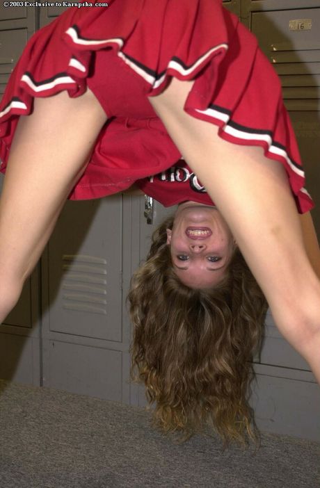 Petite cheerleader Jasmin strips to her panties and spreads her pussy