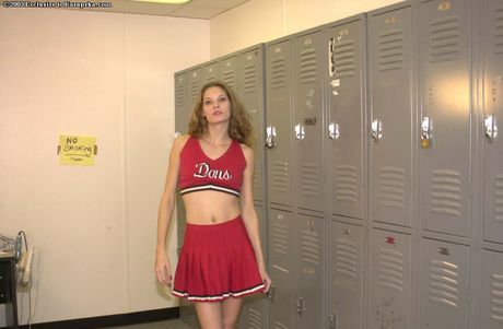Petite cheerleader Jasmin strips to her panties and spreads her pussy