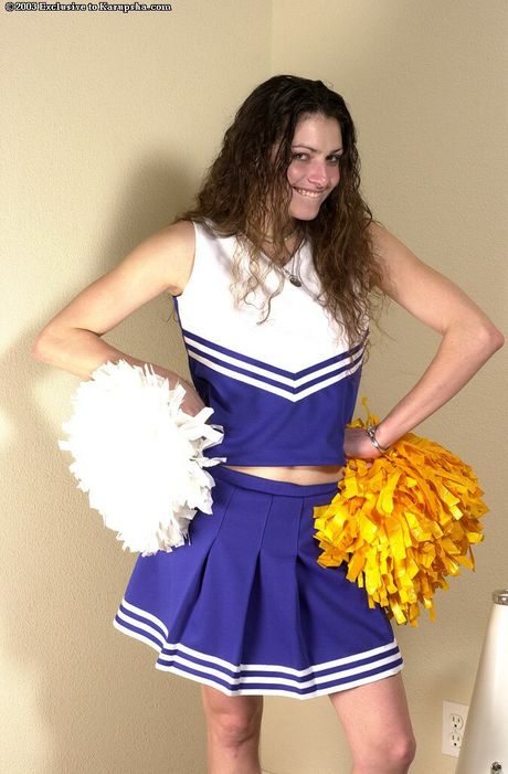 Superb cheerleader Felicity strips and reveals her small tits and bald pussy